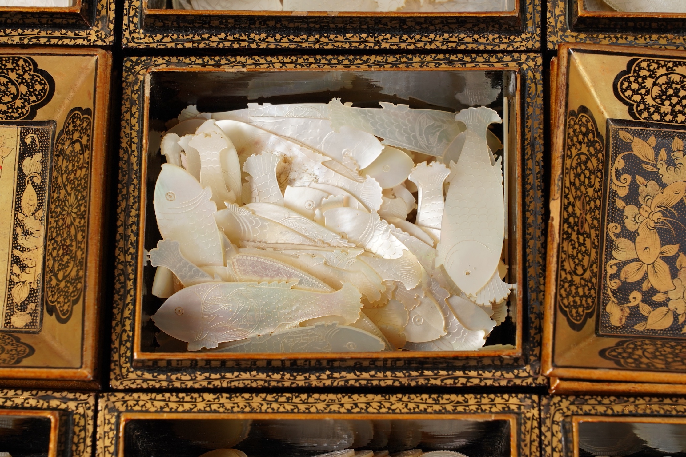 Two Chinese gilt decorated black lacquer games boxes, containing numerous mother-of-pearl counters, 19th century
